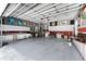Spacious garage with ample storage cabinets, workspace, and vibrant decor at 820 Bayshore Dr, Englewood, FL 34223