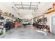 Spacious garage with ample storage, shelving, tools, and a parked car, providing functional space for projects and parking at 820 Bayshore Dr, Englewood, FL 34223