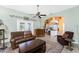 Open living room with a view of the kitchen, comfortable seating, and access to the outdoors at 820 Bayshore Dr, Englewood, FL 34223