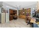 Spacious home office with built-in bookcases, desks, and laminate floors at 820 Bayshore Dr, Englewood, FL 34223