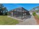 Wide angle view of screened-in pool and surrounding yard at 820 Bayshore Dr, Englewood, FL 34223
