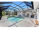 Enjoy the screened-in pool with a star design, alongside a patio area perfect for outdoor entertaining at 820 Bayshore Dr, Englewood, FL 34223