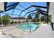 Sparkling pool with screened enclosure and sun-drenched deck, perfect for outdoor entertaining and relaxation at 820 Bayshore Dr, Englewood, FL 34223
