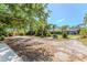 Expansive property featuring a detached garage, seating areas, and lush landscaping, offering space and privacy at 820 Bayshore Dr, Englewood, FL 34223