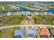 Aerial view of the residential area showcasing canals, manicured lawns, and a clear view of the neighborhood layout at 8251 Arlewood Cir, Port Charlotte, FL 33981