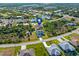 Aerial shot featuring a house within a waterfront community, marked with a location icon, and surrounded by canals at 8251 Arlewood Cir, Port Charlotte, FL 33981