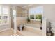 Bright bathroom featuring a glass shower, soaking tub with jets, and plantation shutters allowing plenty of natural light at 8251 Arlewood Cir, Port Charlotte, FL 33981