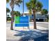 Entrance sign for Englewood Beach at Chadwick Park, framed by palm trees and a glimpse of the blue-and-white pavilion at 8251 Arlewood Cir, Port Charlotte, FL 33981
