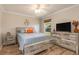 Well-lit bedroom with wood-look flooring, a rustic style bedframe, and a wooden blind-covered window at 8251 Arlewood Cir, Port Charlotte, FL 33981
