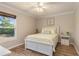 Cozy bedroom showcasing a comfortable bed, wood-look flooring, and bright natural light at 8251 Arlewood Cir, Port Charlotte, FL 33981