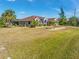 Lovely single Gathering home featuring well-maintained landscaping and mature palm trees at 8251 Arlewood Cir, Port Charlotte, FL 33981