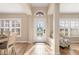 Bright and airy foyer featuring tiled flooring and an arched transom window above the door at 8251 Arlewood Cir, Port Charlotte, FL 33981