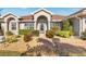 Charming front entrance featuring a decorative door and well-maintained landscaping, leading to a welcoming home at 8251 Arlewood Cir, Port Charlotte, FL 33981