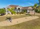 Well-maintained single Gathering home with tropical landscaping and an attractive entrance at 8251 Arlewood Cir, Port Charlotte, FL 33981