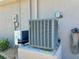 A home's HVAC unit on a stone pad, next to the exterior wall at 8251 Arlewood Cir, Port Charlotte, FL 33981