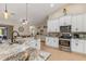 Kitchen with stainless steel appliances, white cabinets, and marble countertops at 8251 Arlewood Cir, Port Charlotte, FL 33981