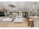 Bright living area featuring tile floors, a ceiling fan, and sliding glass doors to the patio at 8251 Arlewood Cir, Port Charlotte, FL 33981