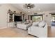 Inviting living room featuring plush furniture and views of the backyard through large windows at 8251 Arlewood Cir, Port Charlotte, FL 33981