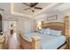 Comfortable bedroom featuring tray ceilings, recessed lighting, wood floors, and an ensuite bathroom at 8251 Arlewood Cir, Port Charlotte, FL 33981