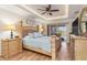 Spacious main bedroom with tray ceilings, recessed lighting, wood floors, and a sliding glass door to the pool area at 8251 Arlewood Cir, Port Charlotte, FL 33981