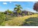 Enjoy outdoor living on the screened lanai overlooking the backyard, perfect for relaxing or entertaining at 8251 Arlewood Cir, Port Charlotte, FL 33981