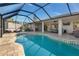 Stunning backyard pool with a screened enclosure, offering a private oasis for relaxation and recreation at 8251 Arlewood Cir, Port Charlotte, FL 33981