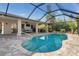 Screened-in pool with spacious patio, an outdoor dining area, hot tub and lush landscaping providing a private backyard oasis at 8251 Arlewood Cir, Port Charlotte, FL 33981