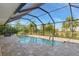 Sparkling screened-in pool surrounded by lush landscaping, offering a private and relaxing outdoor space at 8251 Arlewood Cir, Port Charlotte, FL 33981