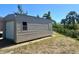 A single story metal utility storage shed in backyard offers ample space for tools and equipment at 8251 Arlewood Cir, Port Charlotte, FL 33981