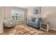 Sitting room with bright window shutters and a cozy cow hide rug at 8251 Arlewood Cir, Port Charlotte, FL 33981