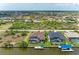 An expansive aerial view showcases a waterfront home with screened pool, dock, and scenic views at 8304 Antwerp Cir, Port Charlotte, FL 33981