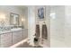 Elegant bathroom featuring tiled accent wall, modern fixtures, vessel sink and framed heron art at 8304 Antwerp Cir, Port Charlotte, FL 33981