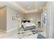 Cozy bedroom featuring a tray ceiling, a patterned rug, and natural lighting at 8304 Antwerp Cir, Port Charlotte, FL 33981