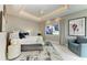 Inviting bedroom with a tray ceiling, large windows, and a comfortable seating area at 8304 Antwerp Cir, Port Charlotte, FL 33981