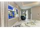 Bright bedroom offers pool views, a custom window, and a comfortable chair at 8304 Antwerp Cir, Port Charlotte, FL 33981