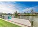 Scenic view of the dock, adorned with vibrant blue chairs, an umbrella, and a charming American flag at 8304 Antwerp Cir, Port Charlotte, FL 33981