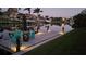 Picturesque waterfront view featuring a private dock with chairs overlooking calm waters at dusk at 8304 Antwerp Cir, Port Charlotte, FL 33981