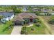 Beautiful home exterior featuring lush landscaping, a well-manicured lawn, and a paver driveway leading to an attached two-car garage at 8304 Antwerp Cir, Port Charlotte, FL 33981