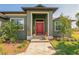 Welcoming entrance with a bright red double door and a stone pathway leading to the home at 8304 Antwerp Cir, Port Charlotte, FL 33981