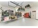 Well-organized garage with ample storage solutions, including shelves, overhead racks, and tool cabinets at 8304 Antwerp Cir, Port Charlotte, FL 33981