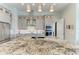 Kitchen with island, granite countertops, stainless steel appliances, and modern lighting at 8304 Antwerp Cir, Port Charlotte, FL 33981