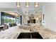 Kitchen island with granite countertops, stainless steel appliances, and open floor plan at 8304 Antwerp Cir, Port Charlotte, FL 33981
