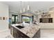 Kitchen island with granite countertops, stainless steel appliances, and open floor plan at 8304 Antwerp Cir, Port Charlotte, FL 33981