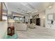 Open-concept living room featuring tray ceilings, tile floors, modern decor, and a large sliding glass door to the outdoor living space at 8304 Antwerp Cir, Port Charlotte, FL 33981
