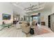 Open floor plan with a view of the modern living room, dining area, and kitchen, all bathed in natural light and stylish decor at 8304 Antwerp Cir, Port Charlotte, FL 33981