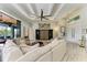 Spacious living room boasts tray ceilings, tile flooring, modern furnishings, and seamless access to the outdoor living area at 8304 Antwerp Cir, Port Charlotte, FL 33981