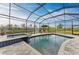 Enclosed pool with spa, outdoor furniture, and view of a canal in a private backyard at 8304 Antwerp Cir, Port Charlotte, FL 33981