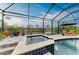 Enclosed pool with spa and outdoor furniture overlooking the canal at 8304 Antwerp Cir, Port Charlotte, FL 33981
