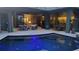 Inviting pool with an outdoor living space, featuring comfortable seating and seamless indoor-outdoor transition at 8304 Antwerp Cir, Port Charlotte, FL 33981