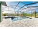 Enclosed pool and spa with view of the canal and tropical foliage beyond at 8304 Antwerp Cir, Port Charlotte, FL 33981